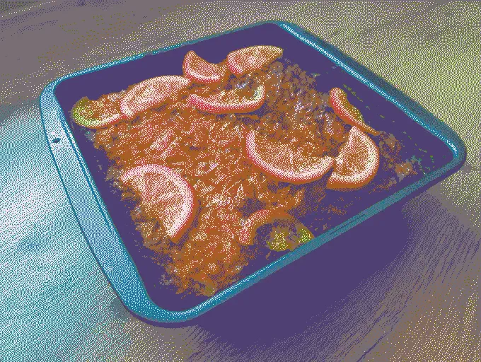 
              Greek orange cake in a dark baking tray
            