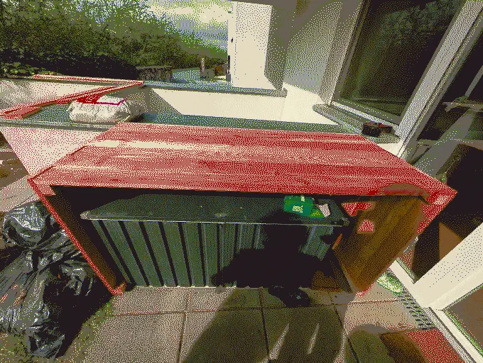 
              Three sides of the planter box are screwed together. The U-shaped construct rests over a garden toolbox
            